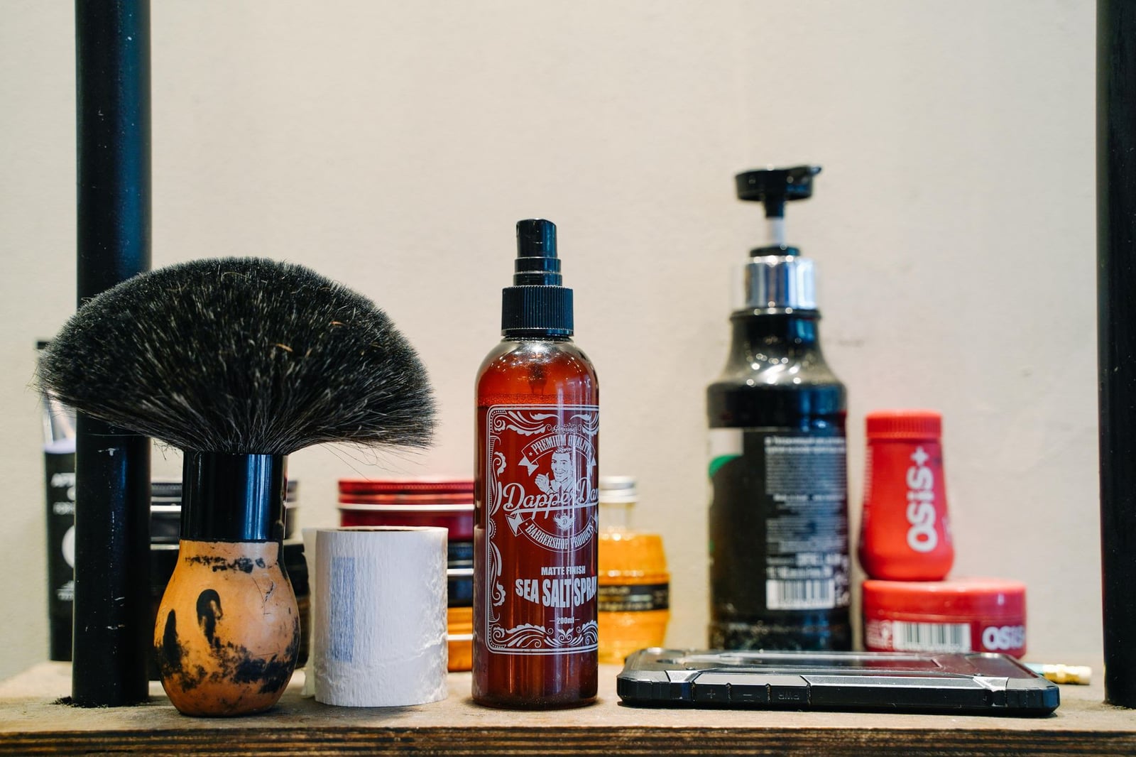 Una vista detallada de herramientas de barbero y productos de grooming en una mesa de salón.