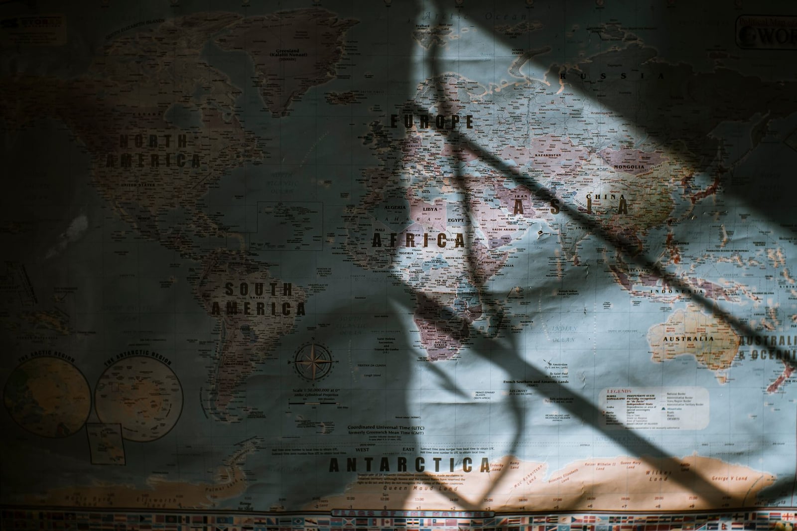Mapa del mundo con la luz del sol proyectando sombras dramáticas sobre su superficie.