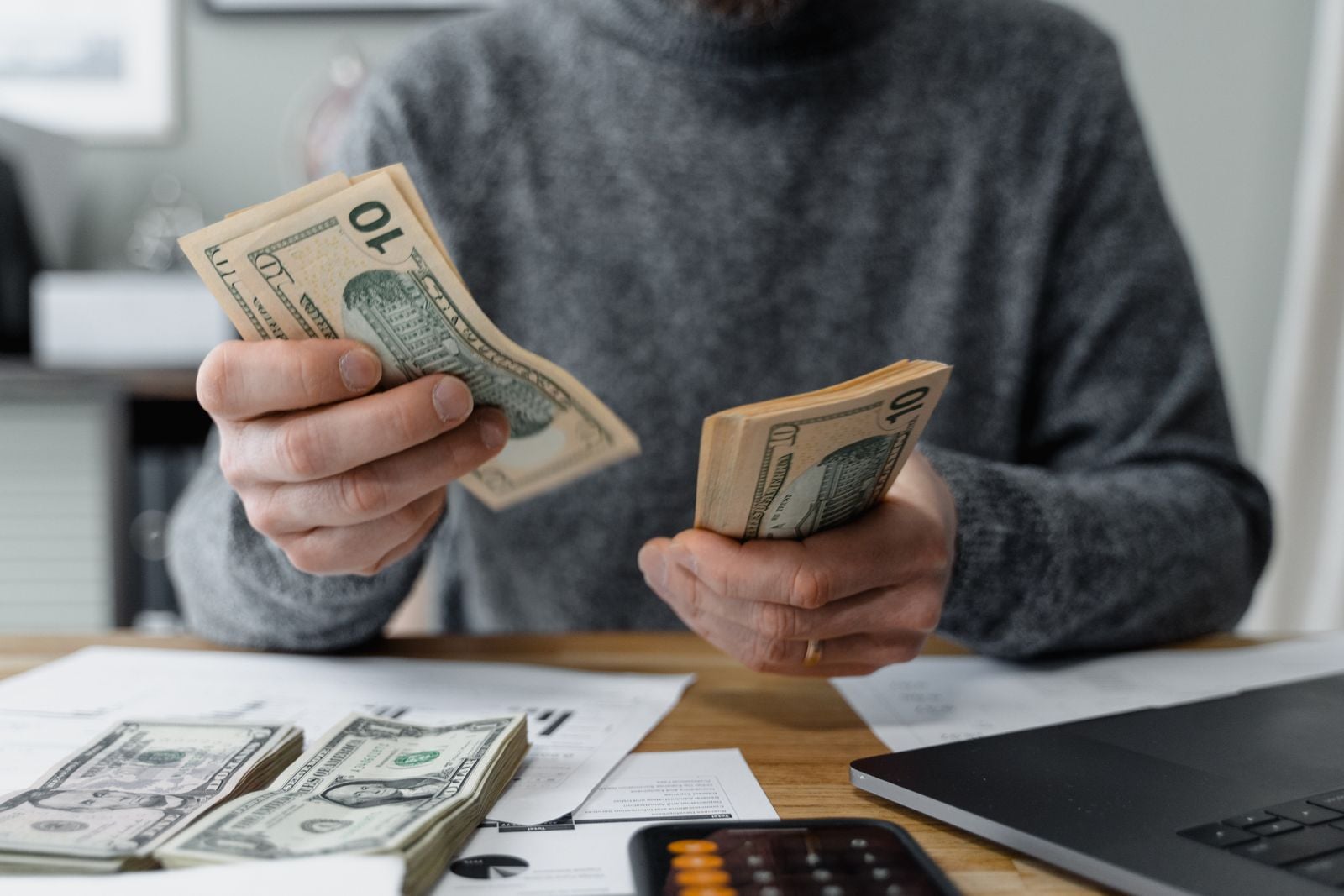 Persona contando billetes de dólar