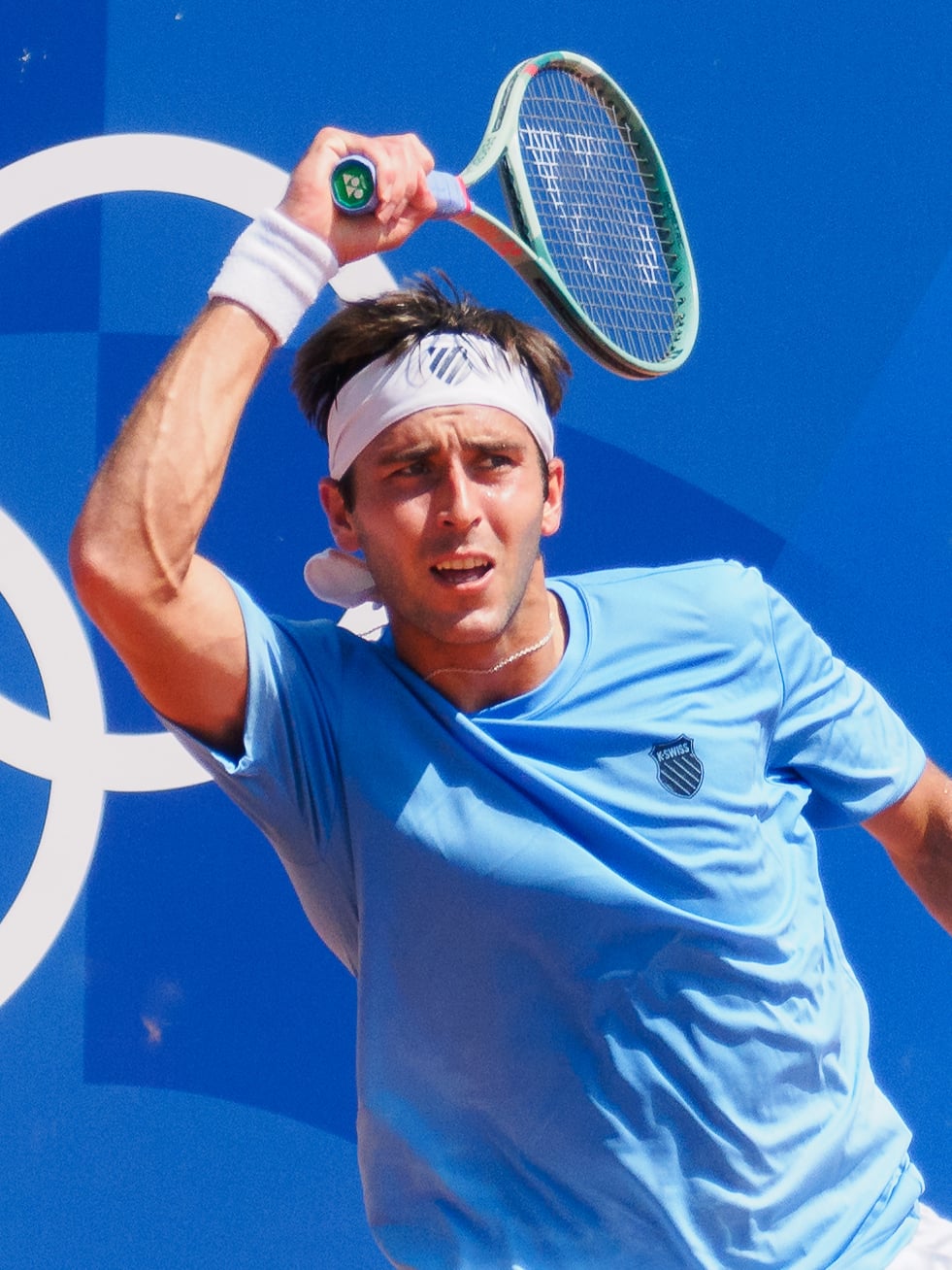 Tomás Martin Etcheverry hitting a forehand during his first round match against Thiago Seyboth Wild at the 2024 Paris Olympics