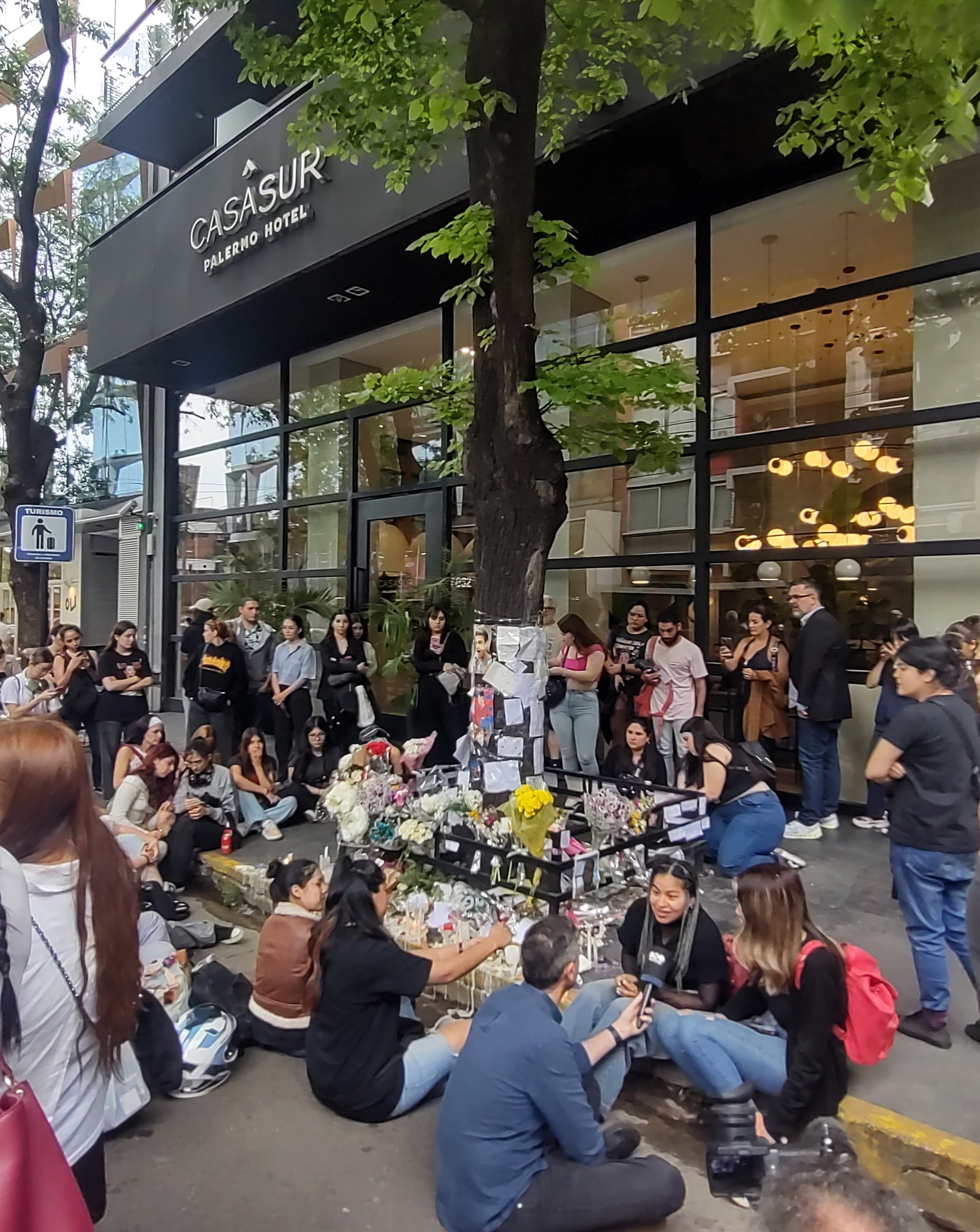 Group of fans gathered in front of the Hotel "Casa Sur", where Liam Payne passed away, placing floral offerings and photos of him. Palermo neighborhood, Buenos Aires, Argentina.