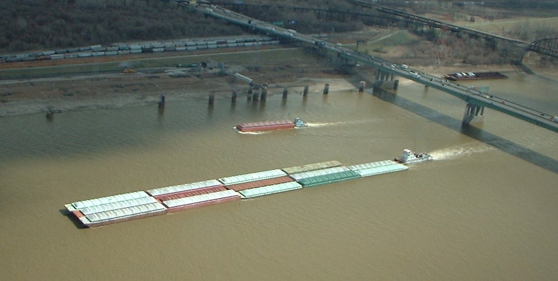 A barge on the Mississippi river after passing under the Poplar St Bridge. The picture is taken from the top of the Gateway Arch in St. Louis.