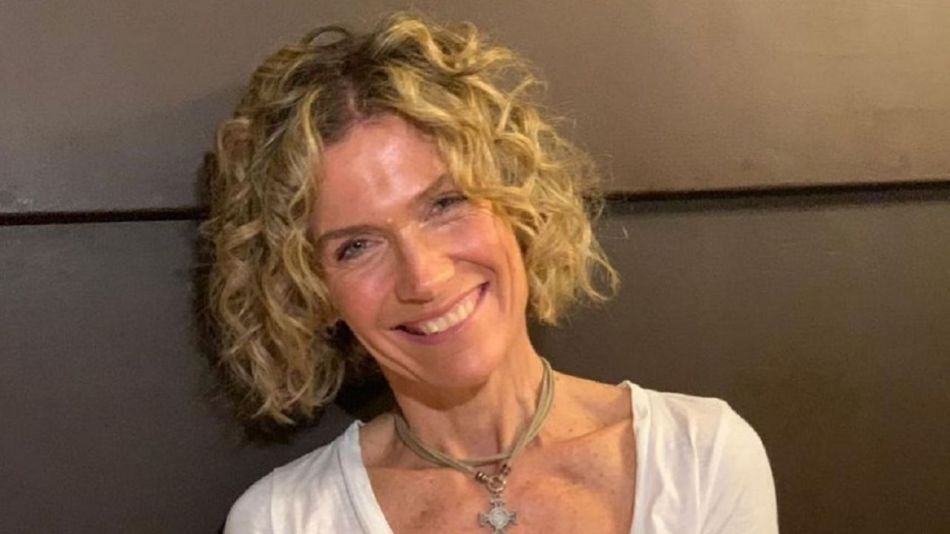 podcast recording studio with two microphones and ring light, warm interior light, no people visible, wooden desk setup