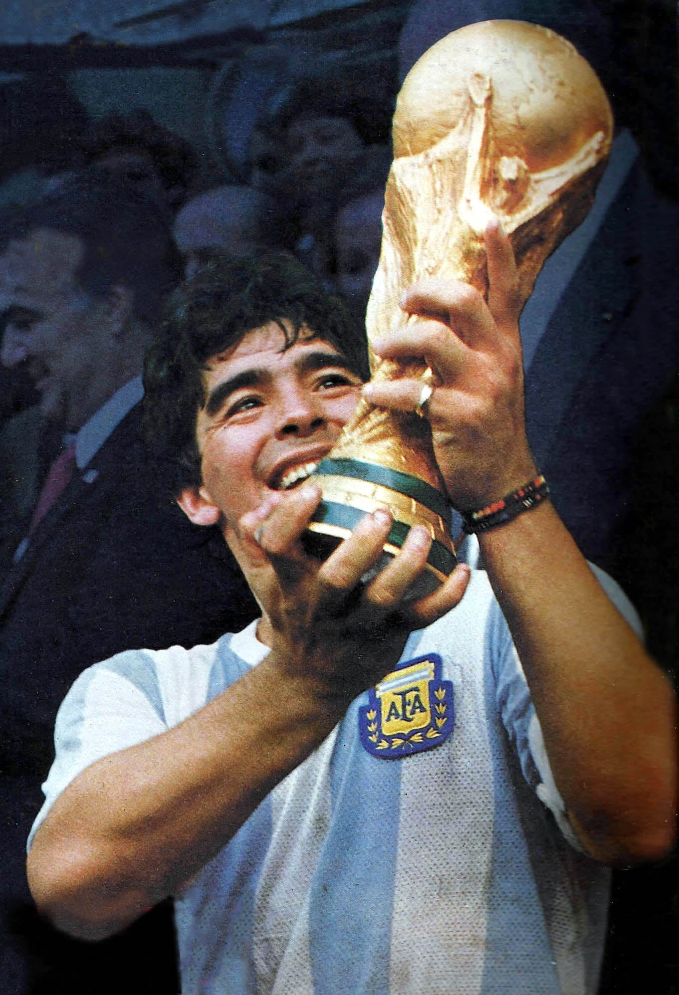 Diego Maradona holding the FIFA World Cup trophy after winning the final against West Germany.
