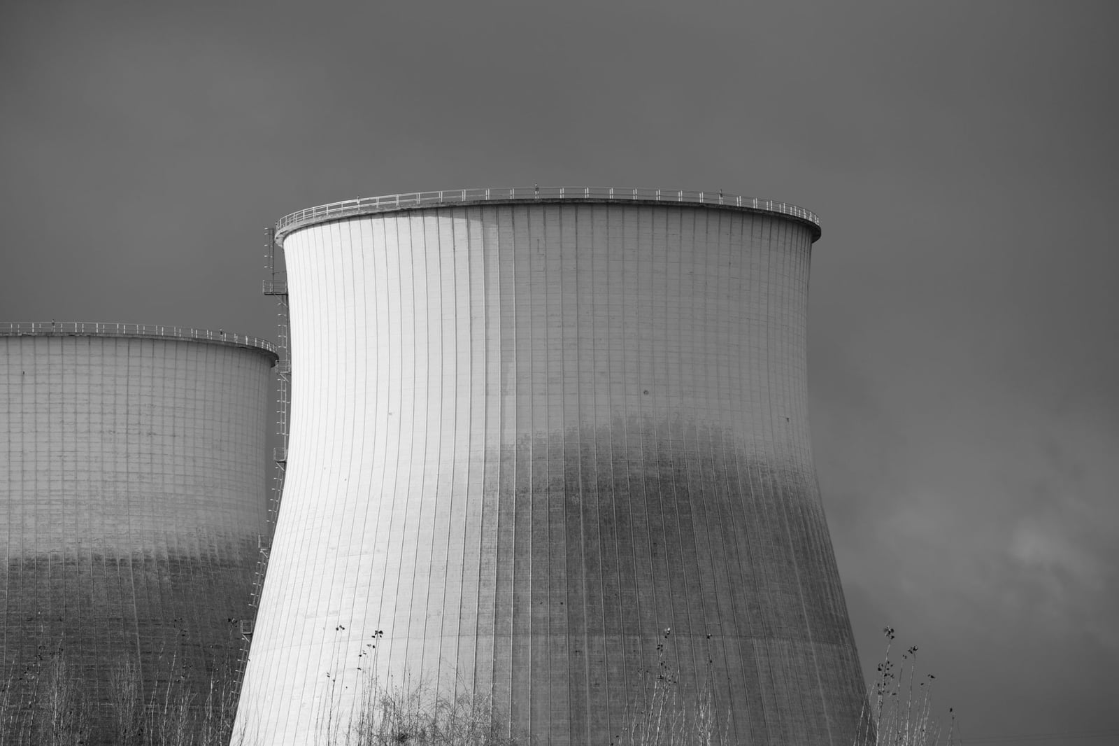 Representación elegante en blanco y negro de las torres de enfriamiento en una planta nuclear, simbolizando energía e industria.