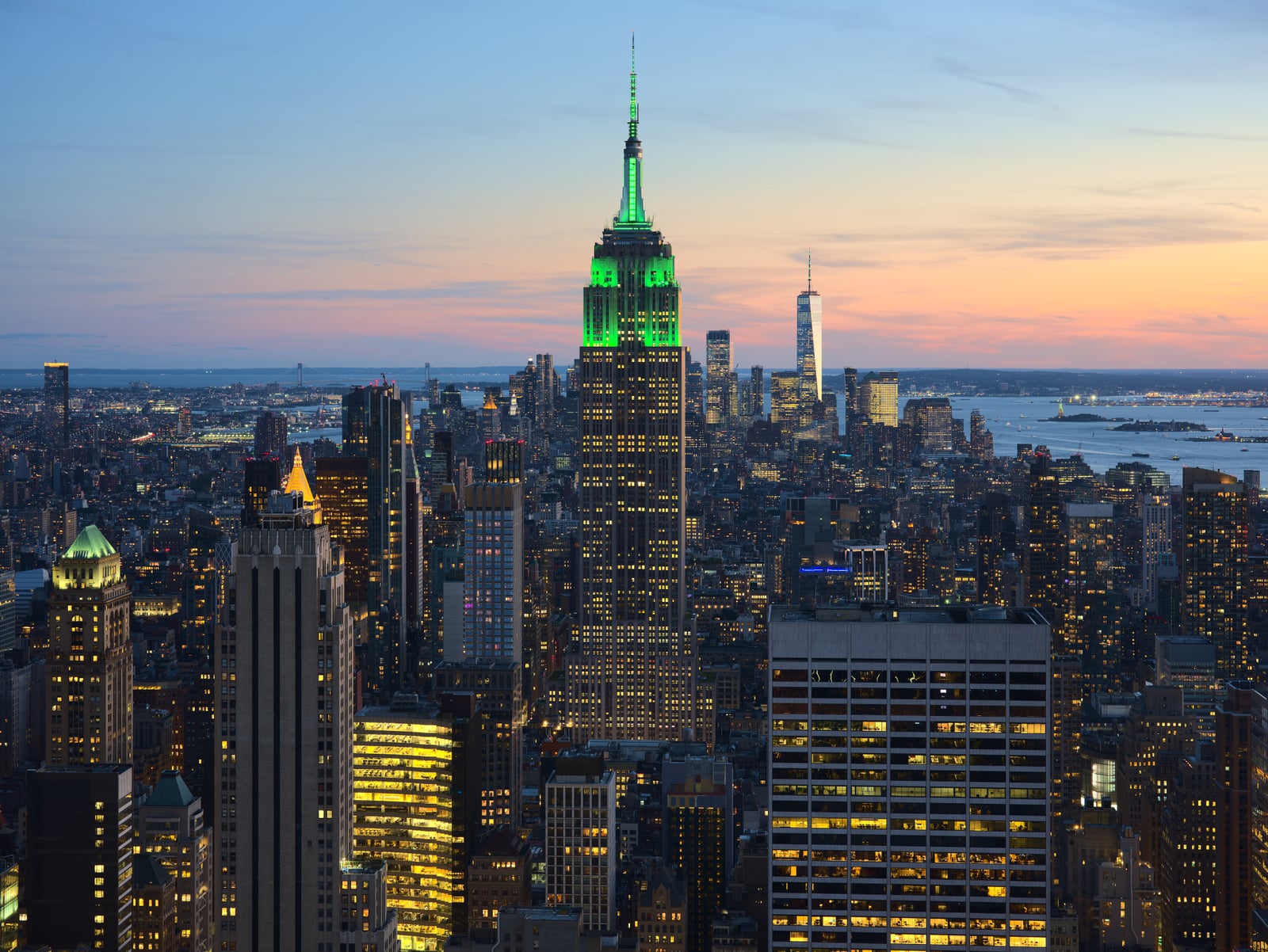View of the Empire State Building in New York City from the Top of the Rock at 30 Rockefeller Plaza during sunset. The tower was illuminated in green in honor of Climate Week NYC.[1]