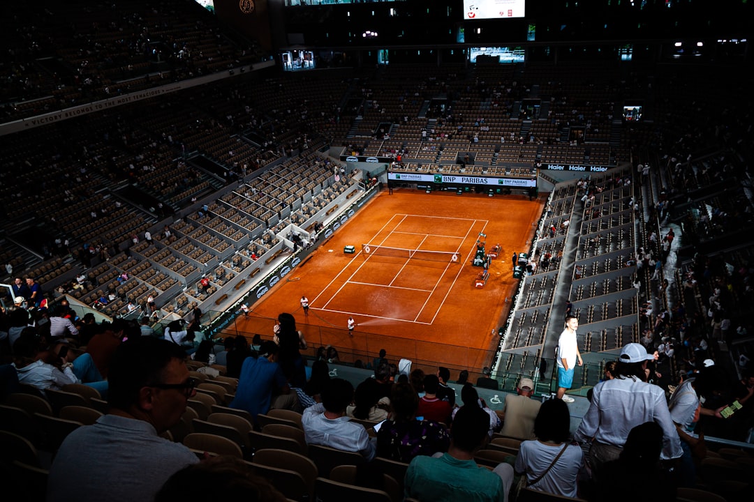 Tennis match at a large stadium with spectators.