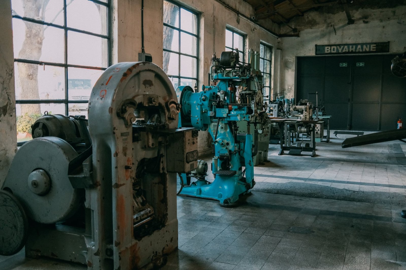 Interior de una antigua fábrica que muestra máquinas y equipos antiguos.