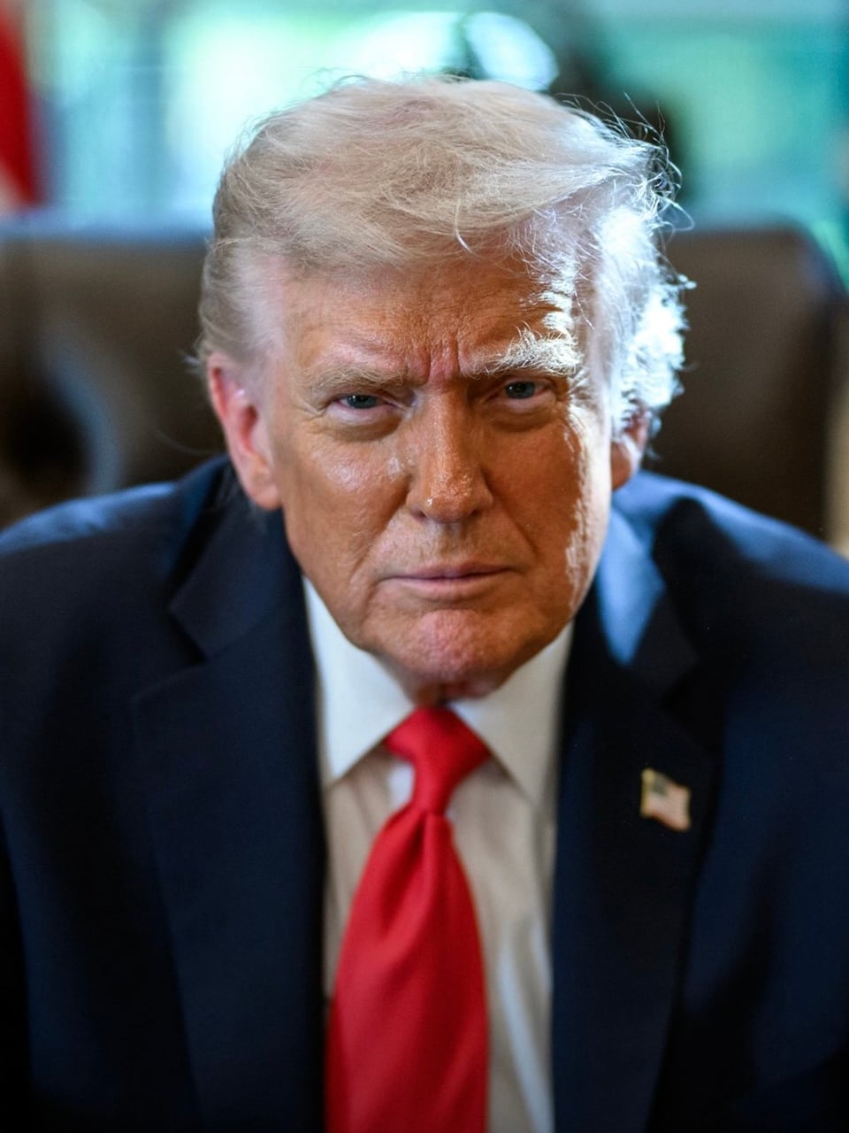 President Donald Trump sitting at the Resolute Desk to pose for a portrait taken by Daniel Torok