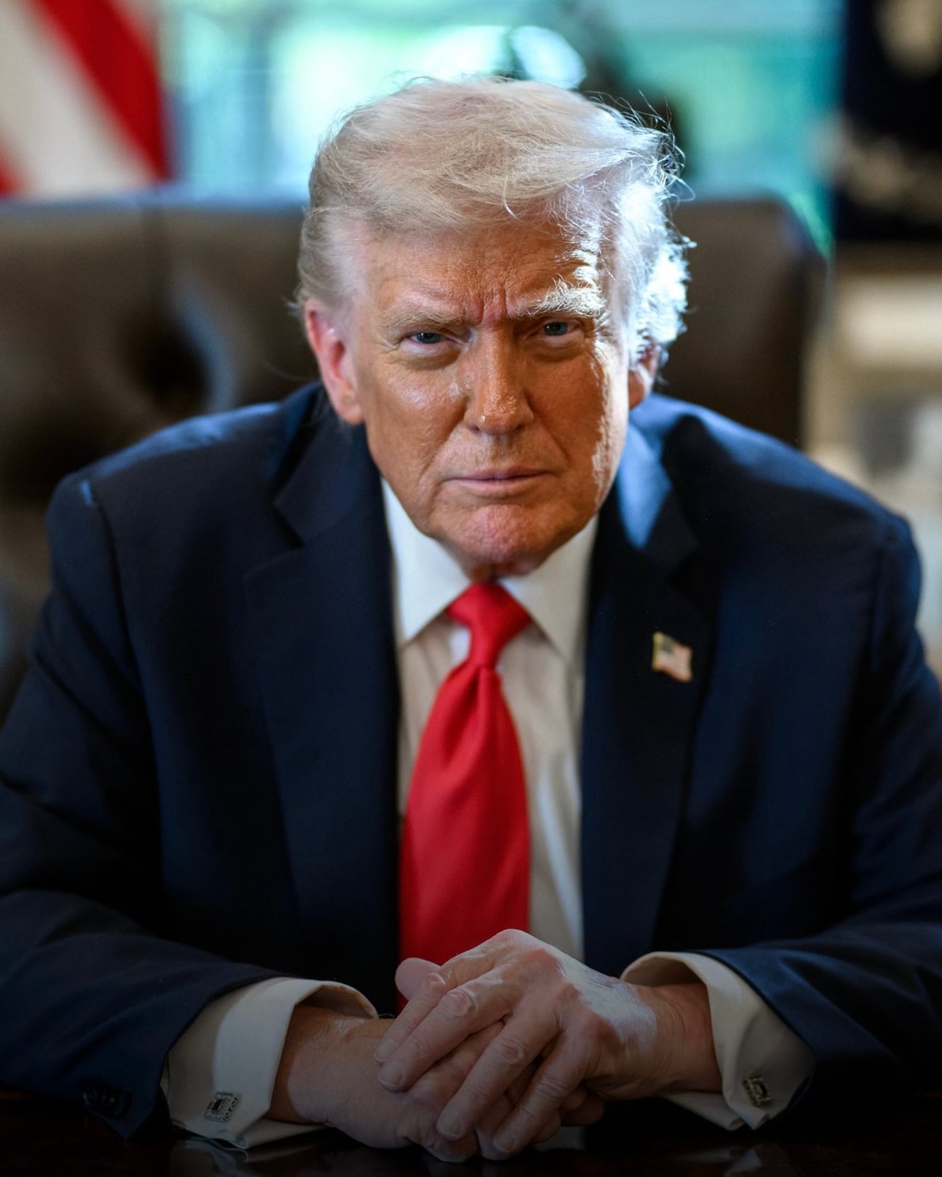 President Donald Trump sitting at the Resolute Desk to pose for a portrait taken by Daniel Torok
