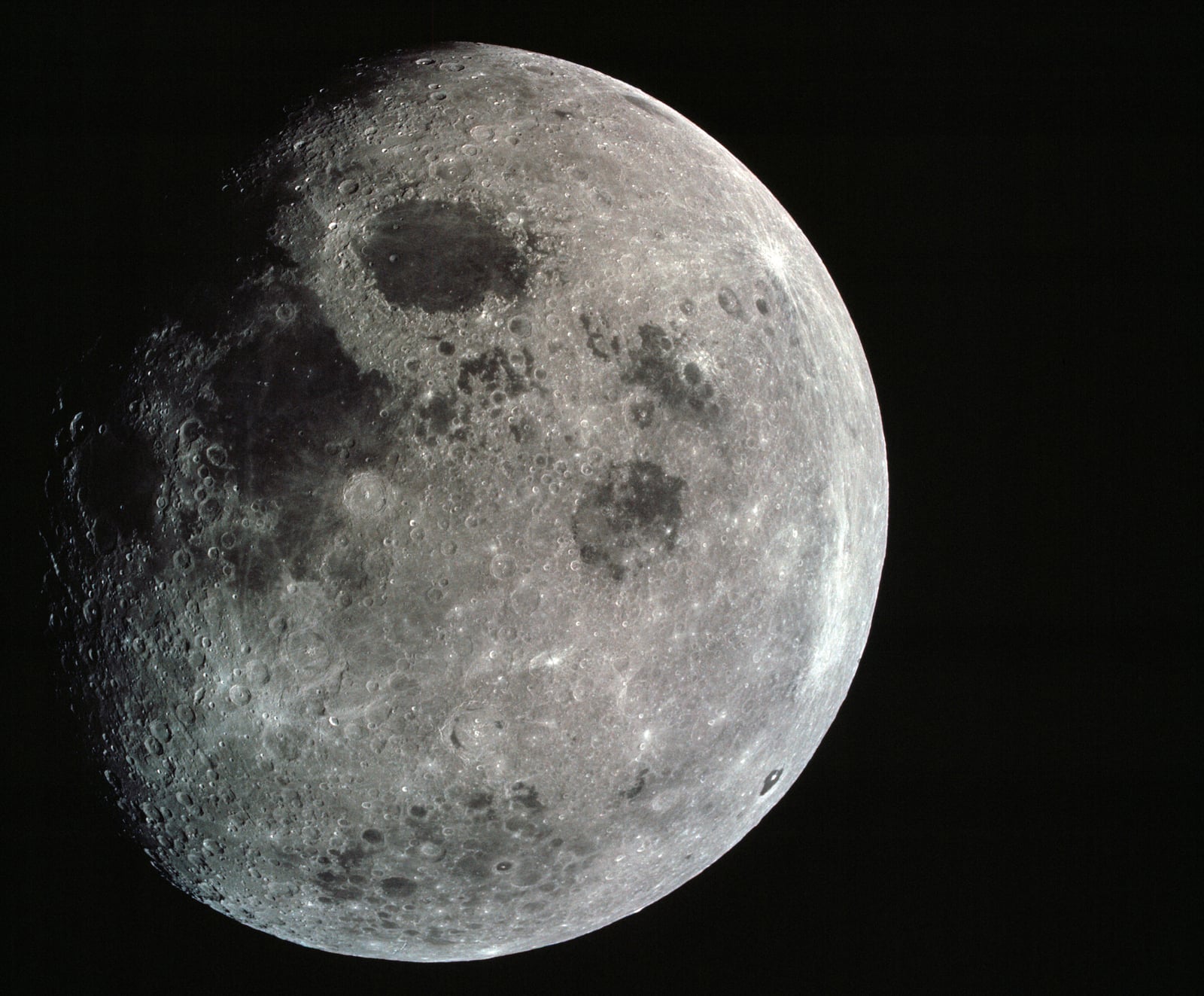 This photograph of a nearly full moon was taken from the Apollo 8 spacecraft at a point above 70 degrees east longitude. (Hold picture with moon's dark portion at left). Mare Crisium, the circular, da